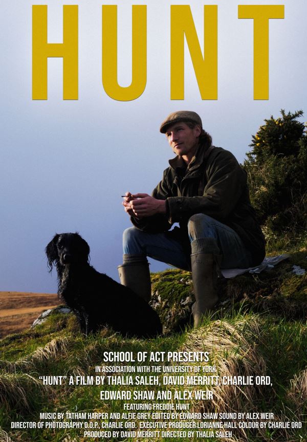 A poster of the documentary HUNT, a gentleman sat on a pebbled beach with a dog